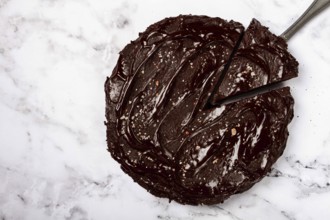 Chocolate cake, round cake, on a marble light table, top view, homemade cakes, no people
