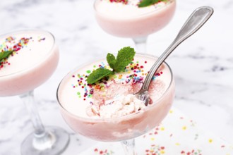 Fruit mousse, made from jelly and cottage cheese, in glasses, decorated with sprinkles and mint,
