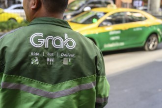 Bangkok, Thailand. March 25th 2025. Ride, Eat, Deliver, the Grab food delivery service logo