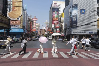 Bangkok, Thailand. March 25th 2025. Tourists crossing Yaowarat Road, the heart of Chinatown and
