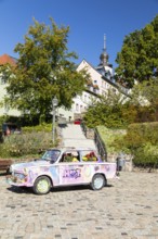 Colourfully painted and planted Trabant car on the old market in Hohenstein-Ernstthal, Saxony,