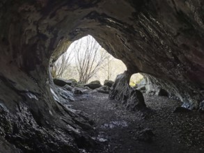 View from a mystical cave, with uneven rocks inside, Quack Castle, Franconian Switzerland, Upper