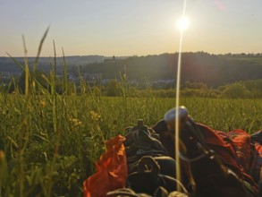 A picnic in a meadow as the sun sets and a panoramic view of the Rosenberg Fortress, Kronach,