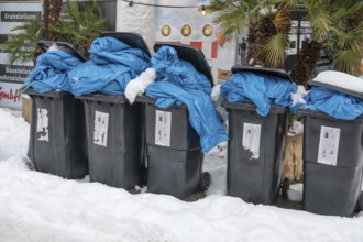 Overfilled garbage cans in the snow for collection, pedestrian zone, Nuremberg, Middle Franconia,
