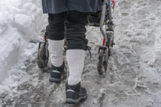 Detail, elderly man pushes his walker through slush in the city, Nuremberg, Middle Franconia,