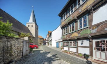 Alley with half-timbered houses and cobblestones at St. Nikolai church, half-timbered town of