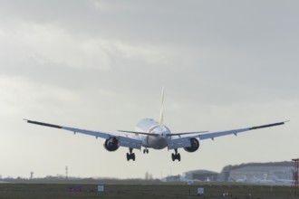 Boeing 777 commercial passenger airliner jet aircraft of Emirates airways landing on the runway at