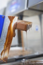 Flowing chocolate from a chocolate mold, vegan chocolates production, Haselstaller Hof, Gechingen,