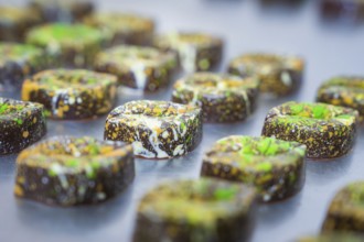 Series of decorated chocolates with artistic colorful patterns, vegan chocolates production,