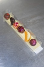 Various chocolates in a transparent gift box on a metal surface, Easter production of regional