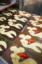 Chocolate bars with Easter bunny relief and small carrot decorations, Easter production of regional