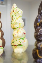 White chocolate figure with colorful food decorations, Easter production of regional products,