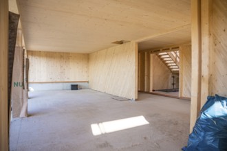 Empty interior of a timber house under construction with visible wooden walls, timber house