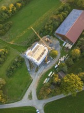 View from above of a construction site next to a building with solar panel on the roof, timber