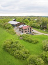 Rural scene with a farm surrounded by green meadows and trees, timber house building, Gechingen,