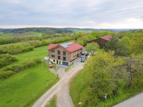 Farmhouse in green landscape under partly cloudy sky, timber house building, Gechingen, Germany