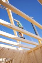 Construction of a wooden building with workers on the roof, timber house construction, Gechingen,
