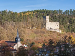 The ruins of Liebenstein Castle above the village with St. John's Church in autumn, Liebenstein,