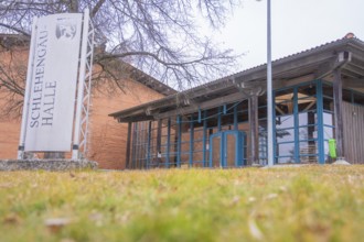 Entrance to Schlehengäu Halle with focus on architecture, surrounded by trees, Schlehengäu