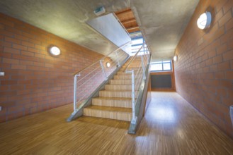 Staircase with wooden floor and brick walls, modern and bright corridor, Schlehengäu sports hall