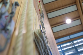 Rope suspension in a sports hall with wooden paneling and lamp light, Schlehengäu Sporthalle