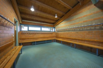 Large brick changing room with benches and coat hooks, Schlehengäu Sporthalle Gechingen, Calw