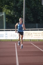 Woman running fast on a track during training, middle distance runner Katharina Jaiser, Gechingen,