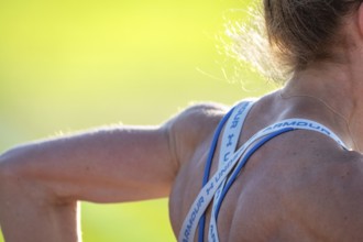 Close-up of a shoulder with sports straps in bright light, middle distance runner Katharina Jaiser,