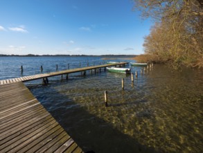 Jetty with rowing boats at Schaalsee in autumn, Schaalsee Biosphere Reserve, Mecklenburg-Western