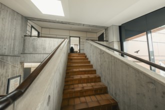 View of a staircase with concrete walls, bright lighting and window view, Gechingen Town Hall, Calw