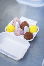 Colourful chocolate eggs are sorted in white cardboard packaging, chocolate quail eggs, Easter