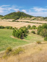 View of hilly landscape with meadows, fields and forests of Wachsenburg Castle in summer,