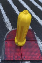 Yellow bollard at a crosswalk, Krakow, Poland