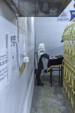 Orthodox Jew praying at the grave of Hasidic Rabbi Elimelech in Lezajsk Jewish Cemetery, Poland
