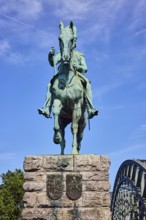 Equestrian statue of Emperor Frederick III, bridge, arched steel arches, sandstone pedestal, tree,