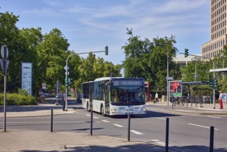 Public bus, general architecture, traffic light intersection, roads, trees, blue sky, cirrus