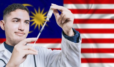 Malaysian doctor holding syringe on Malaysia flag background. Medical professional holding syringe