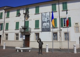 Italy, village of Brescello, the town hall, known from Don Camillo and Peppone, with a bronze