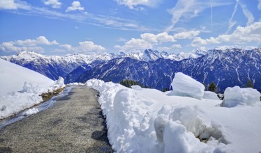 Alpine mountain landscape, hiking trail on the Fellhorn surrounded by snow with panoramic views of