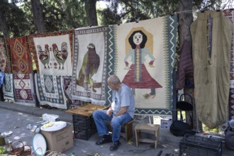 Tbilisi, Georgia. July 11th 2025. Street stall vendor at the Dry Bridge Flea Market selling