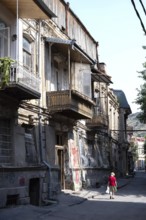 Tbilisi, Georgia. July 29th 2025. A women walks in the quiet streets of Tbilisi old town, with its