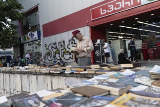 Tbilisi, Georgia. July 7th 2025. A local man browses secondhand books at a street market near the