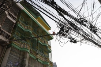 Bangkok, Thailand. March 4th 2025. A tangled mess of cables and wires used for phone and internet