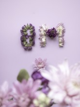 Floral composition creating the numbers 8m against a pastel background, celebrating international