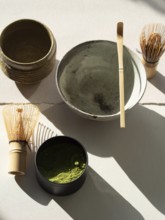 Matcha powder and bamboo whisks ready for preparing a comforting green tea ritual
