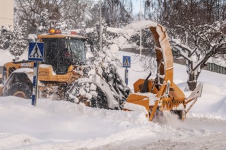 Snow blower clears snow on street in Ystad, Skåne County, Sweden, Scandinavia
