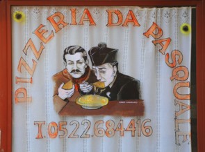 Italy, village of Brescello, advertisement for Pizzeria Pasquale, with a picture of Don Camillo and