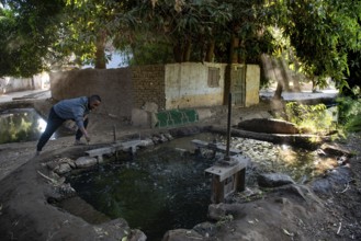Aswan, Egypt. 9th December 2020 A Nubian man controls a sluice gate that channels water from the