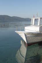 Stunning view of a boat moored in the beautiful harbour of Turkish Riviera seaside town of Akyaka
