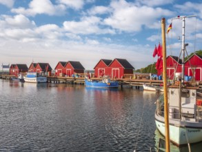 Small red huts and fishing boats in Boltenhagen fishing port, Baltic resort Boltenhagen,